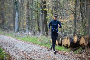 a woman jogging in the forest