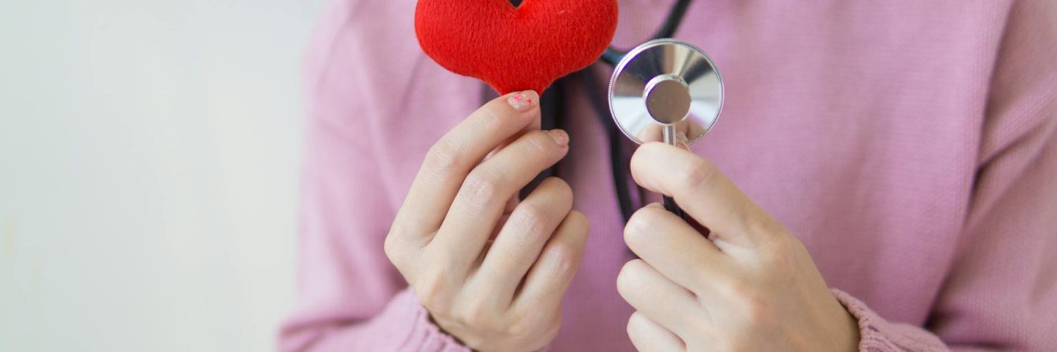 crop woman with stethoscope and heart