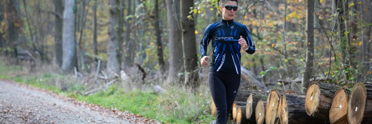 a woman jogging in the forest